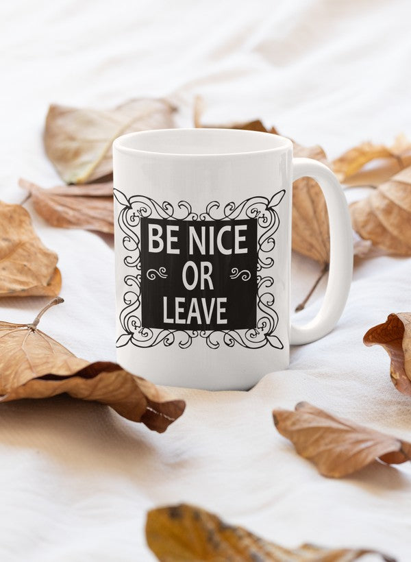 A stylish 11oz ceramic mug with a glossy finish featuring the phrase 'Be Nice Or Leave' in bold letters.