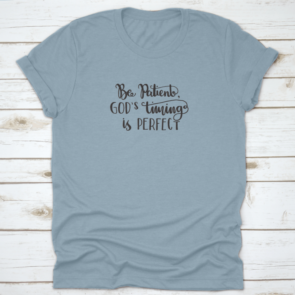 A modern hand lettered quote shirt featuring 'Be Patient God's Timing Is Perfect' in stylish typography, made from soft cotton fabric.