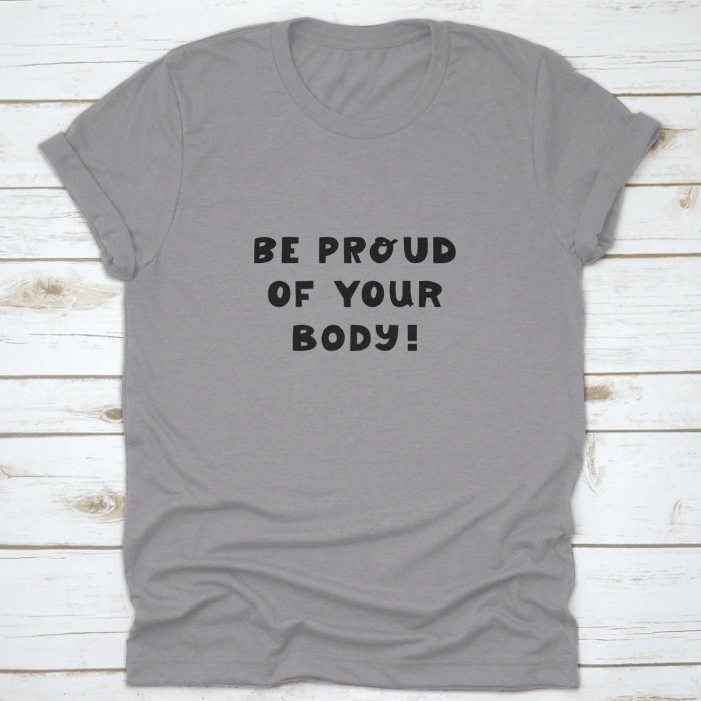 A white t-shirt featuring cute hand-drawn lettering that says 'Be Proud Of Your Body', showcasing a stylish and positive message.