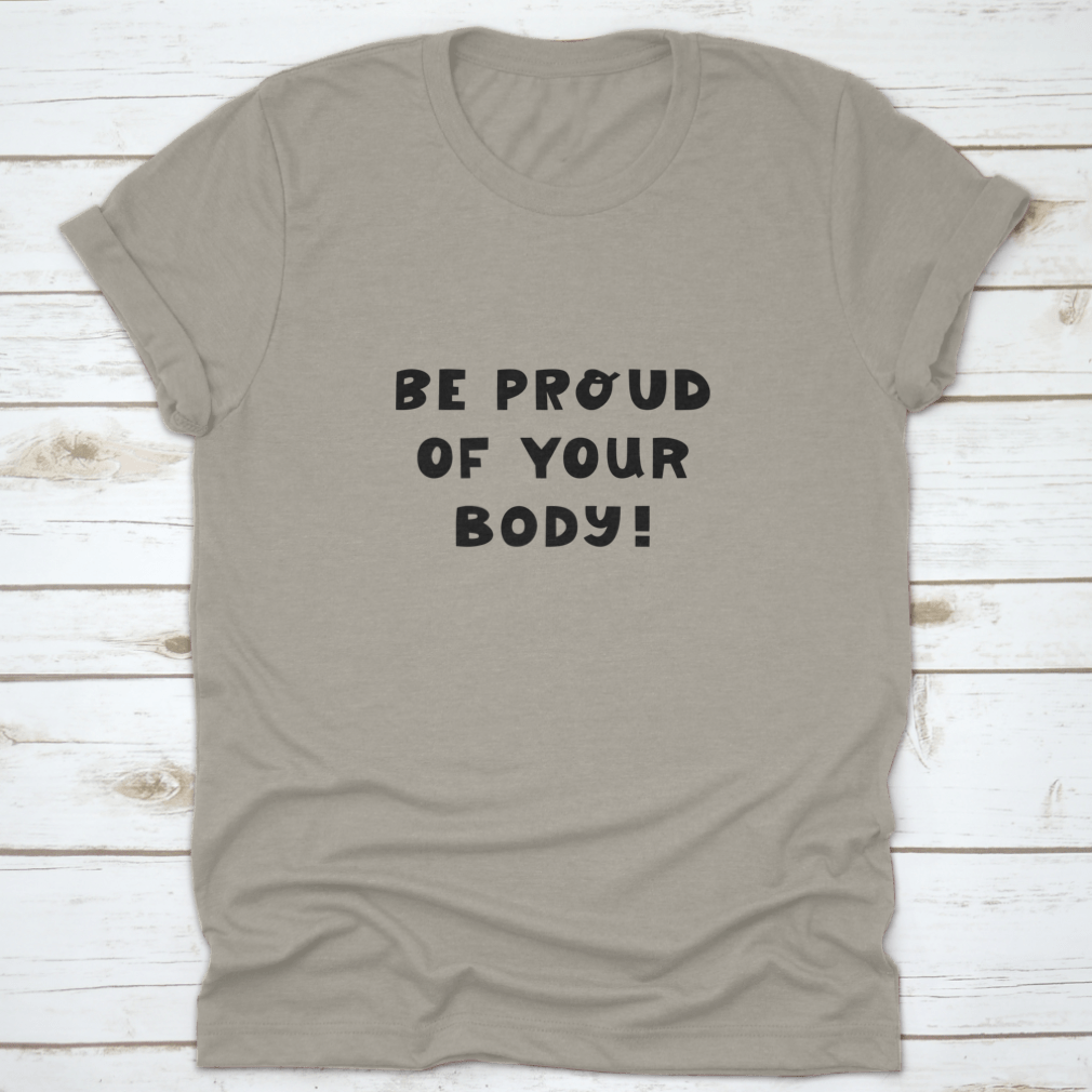A white t-shirt featuring cute hand-drawn lettering that says 'Be Proud Of Your Body', showcasing a stylish and positive message.