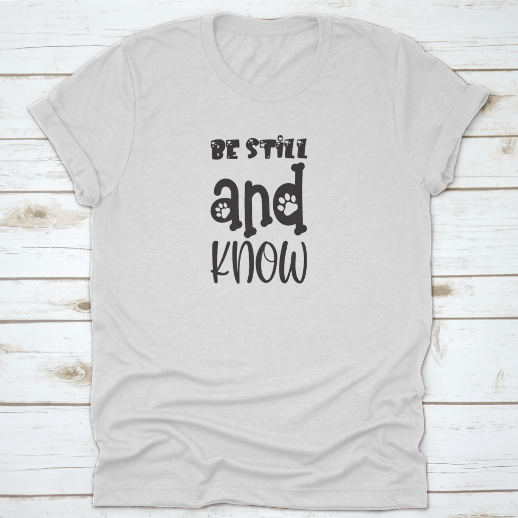 Be Still And Know Black Letter Quote T-Shirt displayed on a mannequin, showcasing its trendy design and comfortable fit.