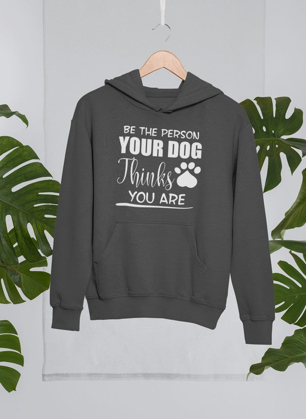 A cozy hoodie featuring the phrase 'Be The Person Your Dog Thinks You Are', designed for dog lovers with an adjustable hood and fleece lining.