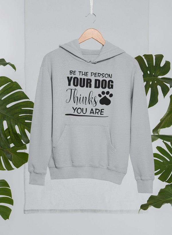 A cozy hoodie featuring the phrase 'Be The Person Your Dog Thinks You Are', designed for dog lovers with an adjustable hood and fleece lining.