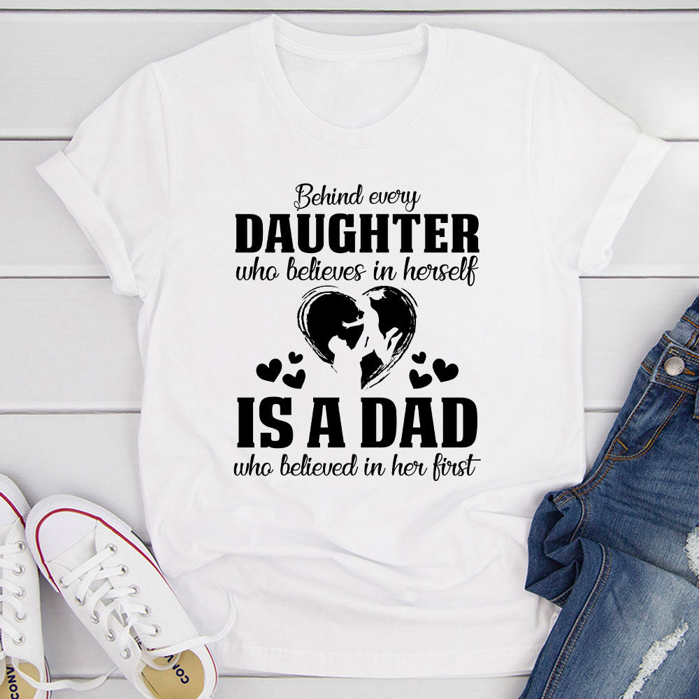 A comfortable t-shirt featuring the phrase 'Behind Every Daughter Who Believes In Herself Is A Dad Who Believed In', made from soft cotton.