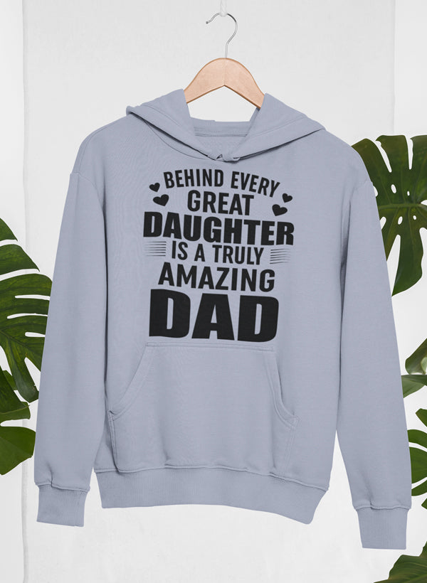 A cozy hoodie with the phrase 'Behind Every Great Daughter Is a Truly Amazing Dad' printed on it, showcasing a warm cotton/poly fleece blend.