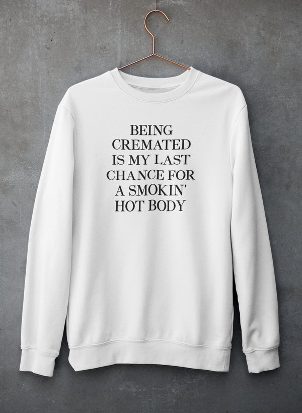 A cozy sweatshirt featuring the humorous phrase 'Being Cremated Is My Last Chance For A Smokin' Hot Body' in stylish typography.