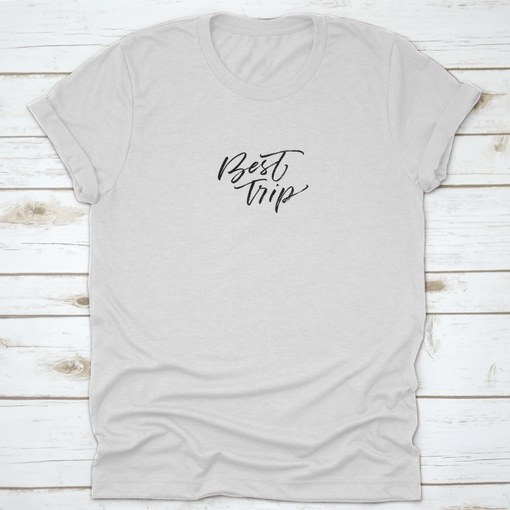 A stylish cotton t-shirt featuring modern brush ink illustration of 'Best Trip Adventure Lettering', perfect for casual wear.
