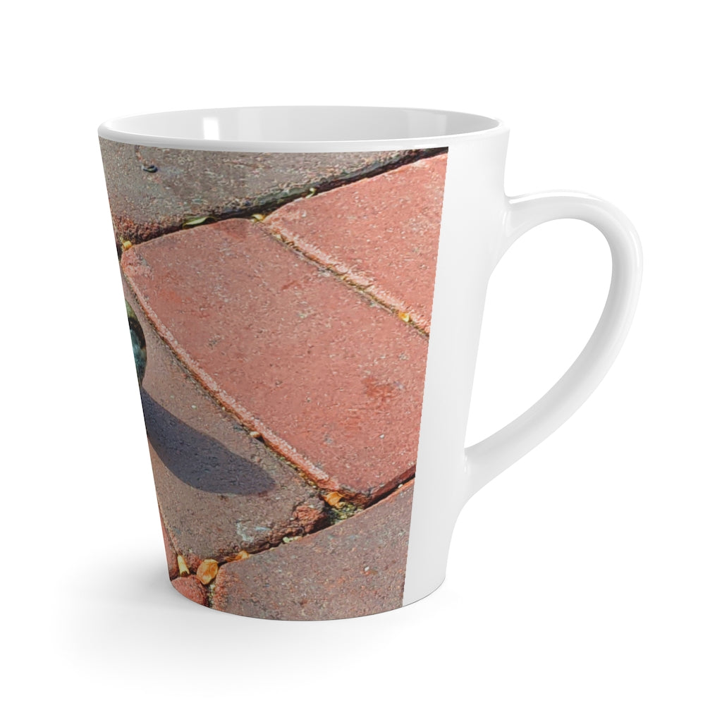 A stylish Bird Latte Mug made of white ceramic, featuring a vibrant bird design and a comfortable C-handle.