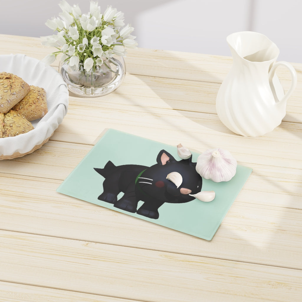 A stylish Black Kitty Cutting Board made of tempered glass, featuring a playful black cat design and four rubber dots for stability.
