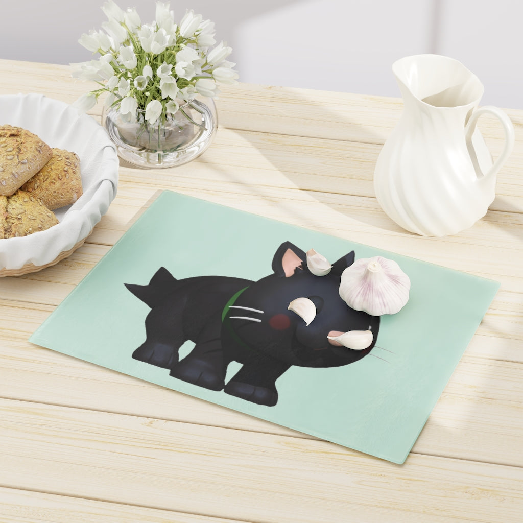 A stylish Black Kitty Cutting Board made of tempered glass, featuring a playful black cat design and four rubber dots for stability.