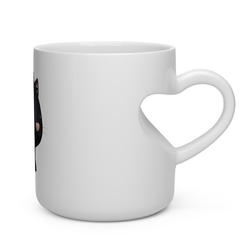 A white ceramic mug with a heart-shaped handle featuring a cute black kitty design, perfect for hot beverages.