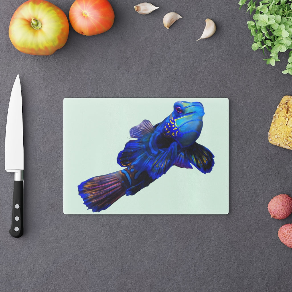 A stylish Blue Fish Cutting Board made of tempered glass, featuring a unique fish design and rubber dots for stability.