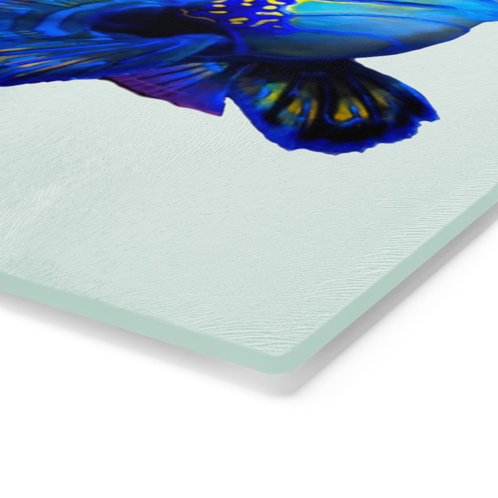 A stylish Blue Fish Cutting Board made of tempered glass, featuring a unique fish design and rubber dots for stability.