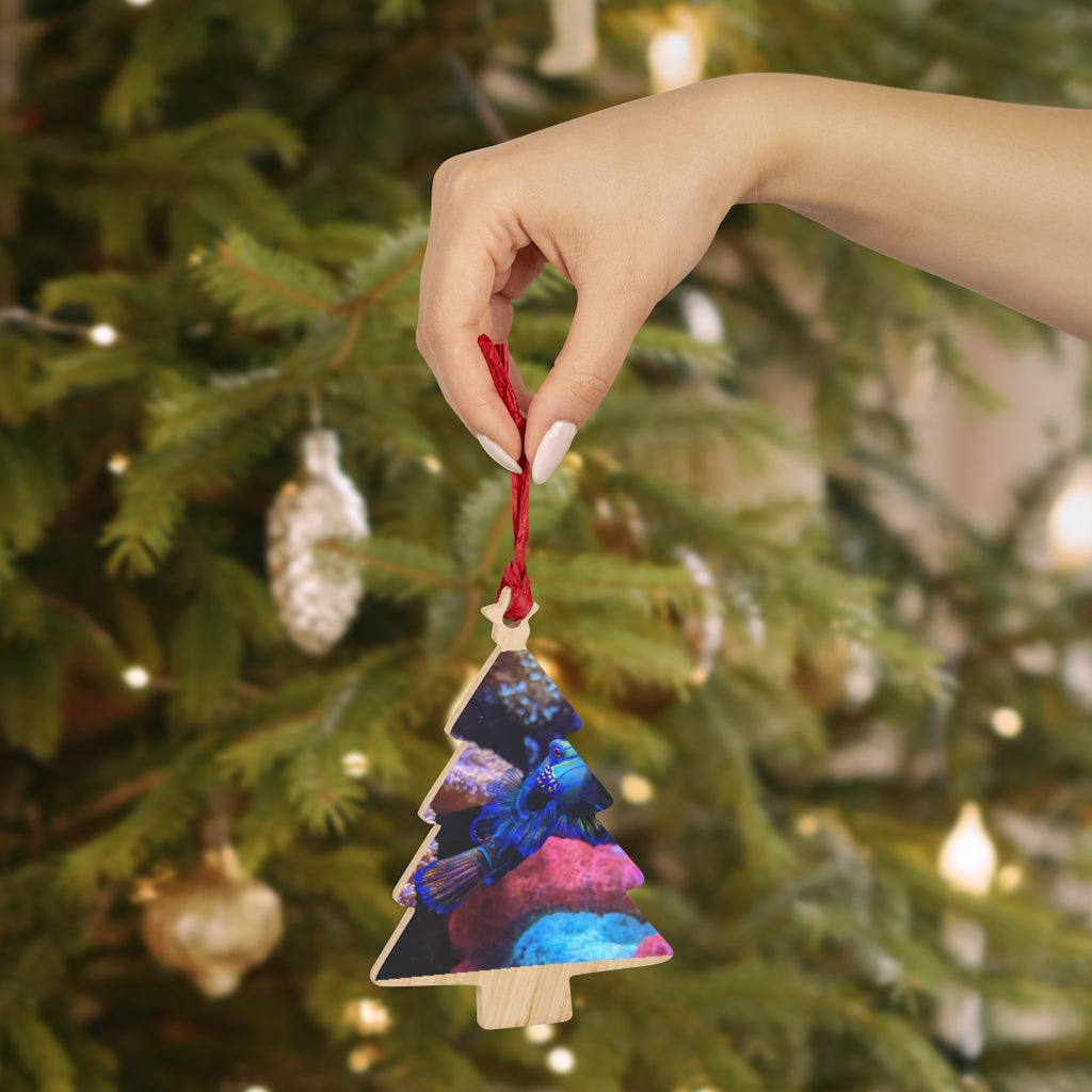 A collection of Blue Fish Wooden Christmas Ornaments in various whimsical shapes, featuring a rustic wood finish and red ribbons for hanging.