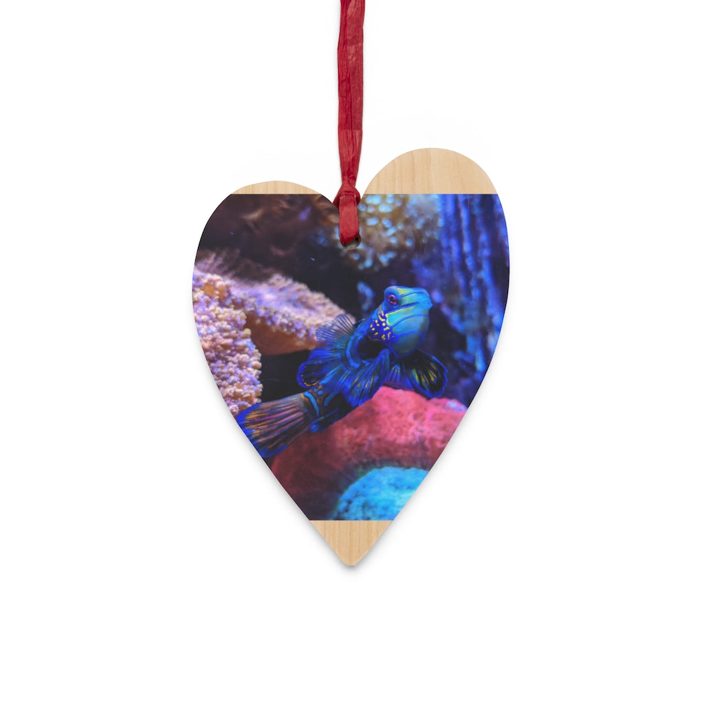 A collection of Blue Fish Wooden Christmas Ornaments in various whimsical shapes, featuring a rustic wood finish and red ribbons for hanging.
