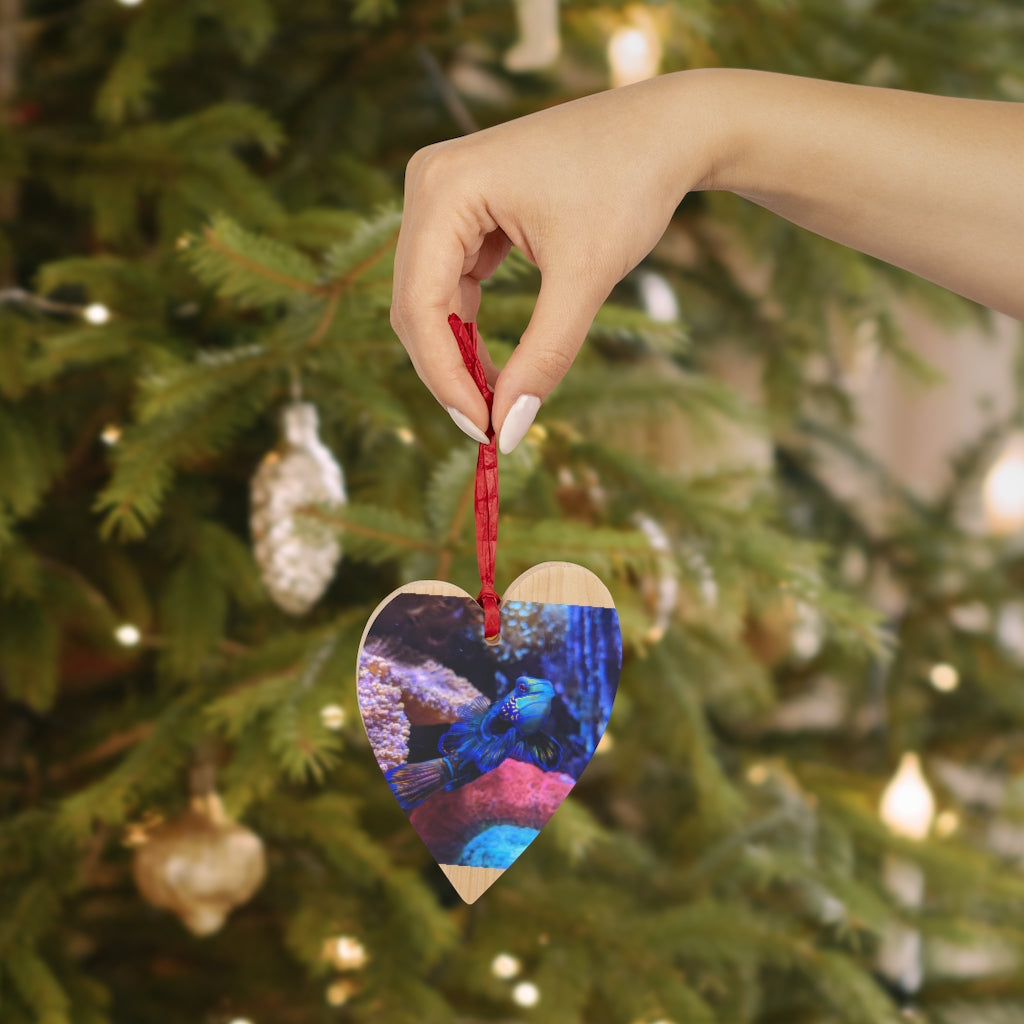 A collection of Blue Fish Wooden Christmas Ornaments in various whimsical shapes, featuring a rustic wood finish and red ribbons for hanging.