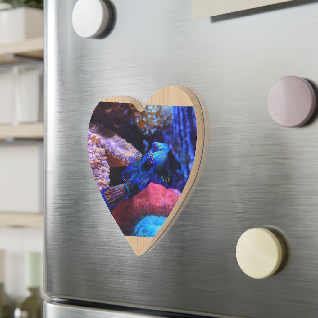 A collection of Blue Fish Wooden Christmas Ornaments in various whimsical shapes, featuring a rustic wood finish and red ribbons for hanging.