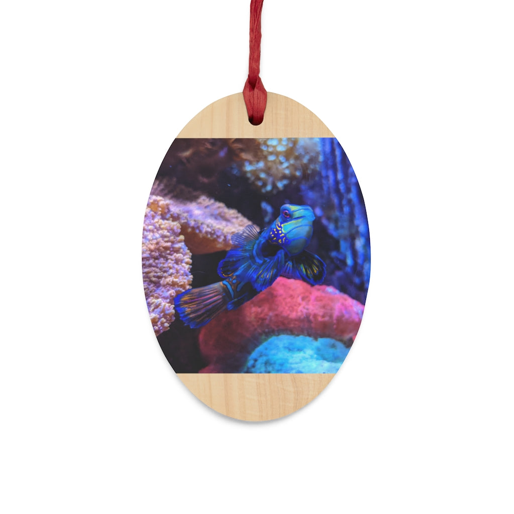 A collection of Blue Fish Wooden Christmas Ornaments in various whimsical shapes, featuring a rustic wood finish and red ribbons for hanging.