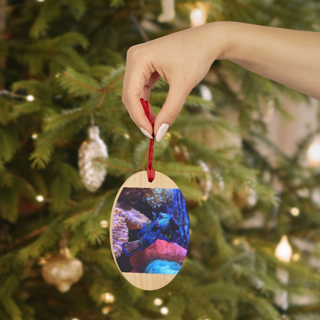 A collection of Blue Fish Wooden Christmas Ornaments in various whimsical shapes, featuring a rustic wood finish and red ribbons for hanging.