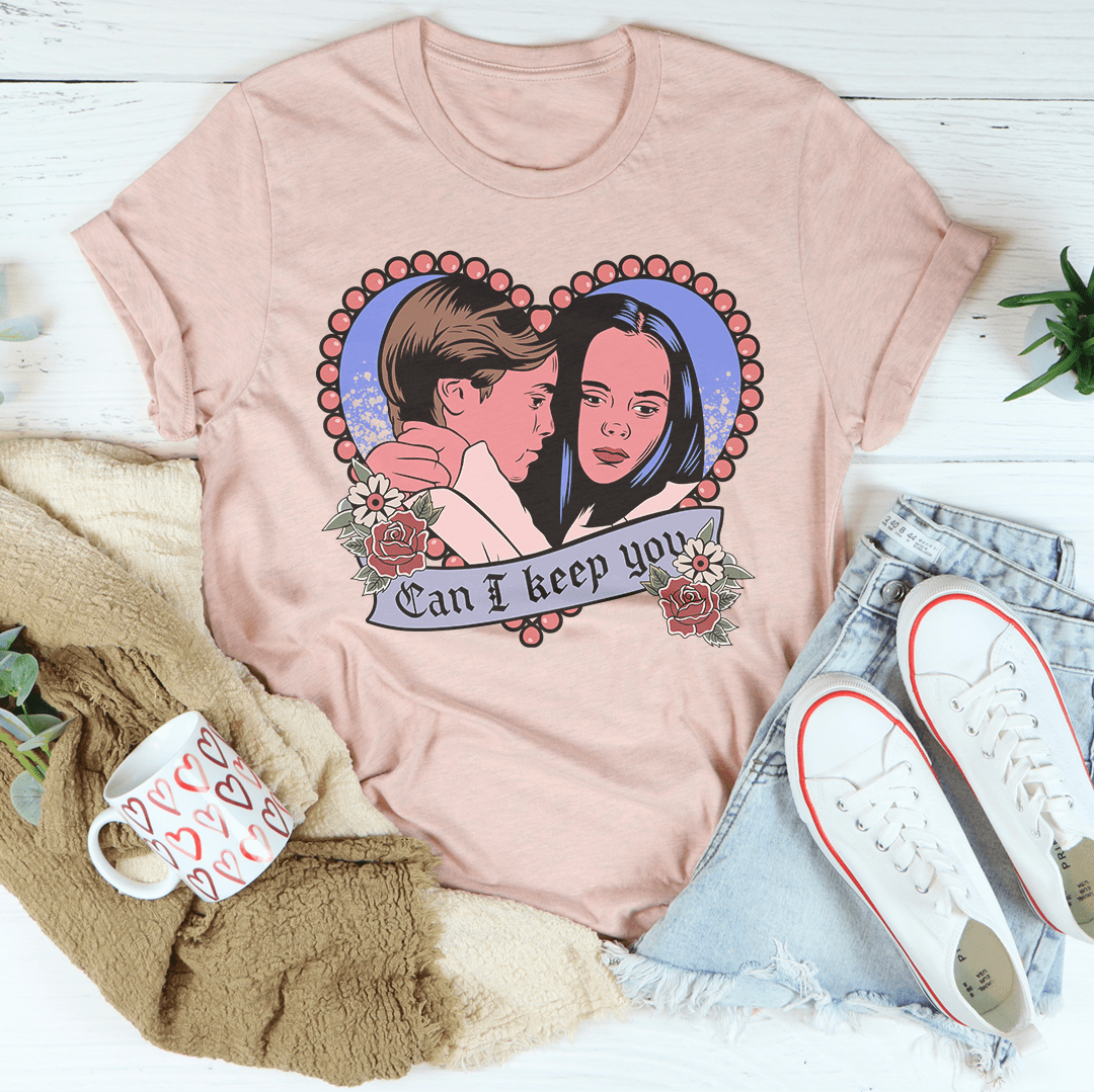A stylish Halloween-themed tee featuring the phrase 'Can I Keep You' printed in vibrant colors on a soft cotton fabric.