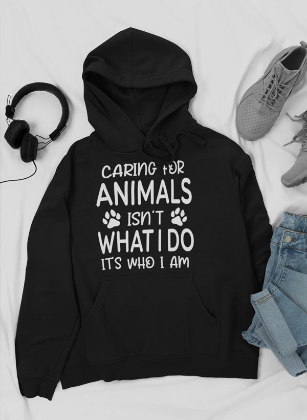 A cozy hoodie featuring the phrase 'Caring for Animals Isn't What I Do It's Who I Am', perfect for animal lovers.