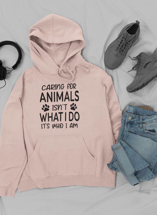 A cozy hoodie featuring the phrase 'Caring for Animals Isn't What I Do It's Who I Am', perfect for animal lovers.
