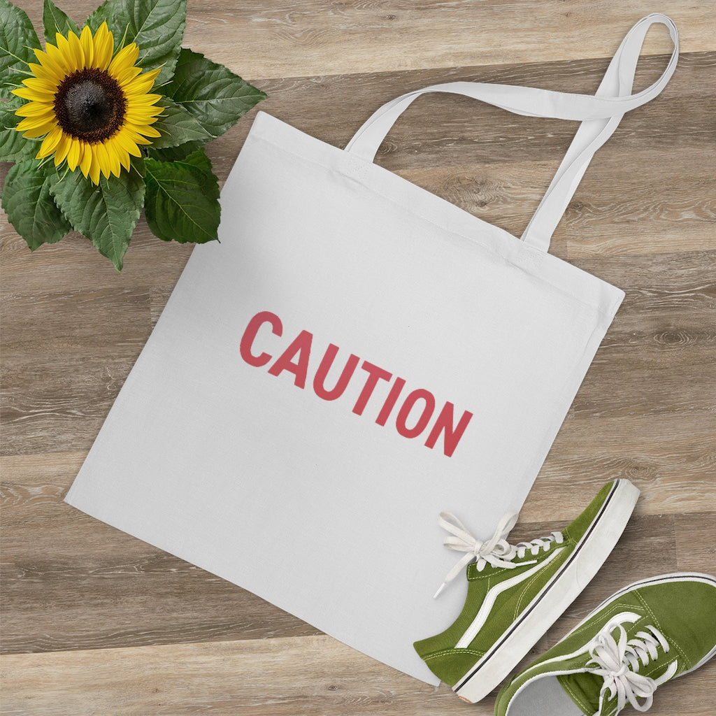 Caution Tote Bag made of 100% cotton with long handles and cross-stitched detailing, available in multiple colors.
