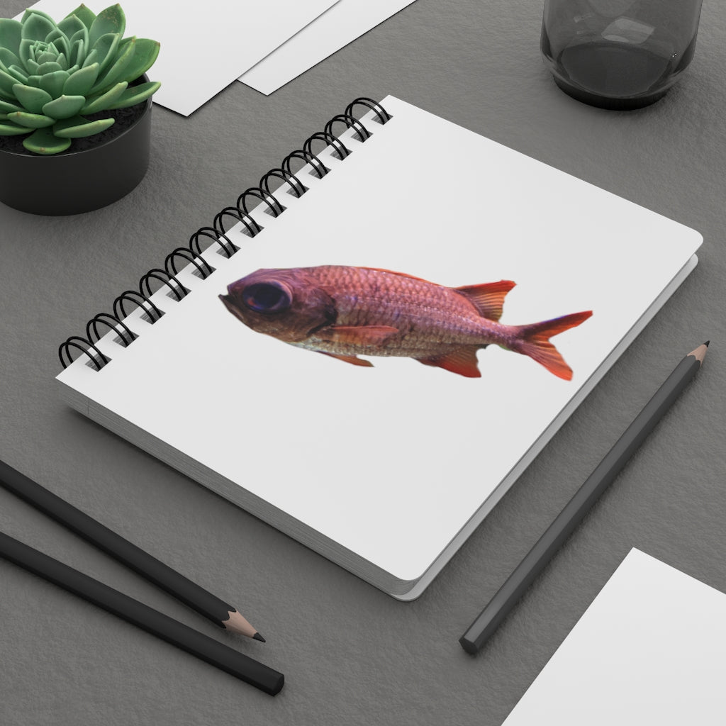 A colorful spiral bound journal featuring a vibrant fish design on a glossy laminated cover, showcasing its durable and stylish appearance.