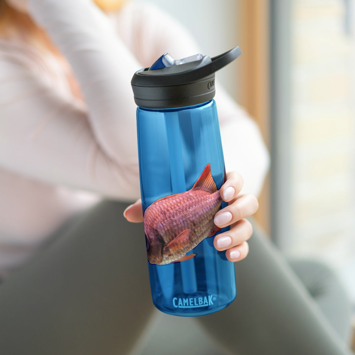 Colorful Fish CamelBak Eddy® Water Bottle in vibrant colors, showcasing its durable design and easy-carry handle.