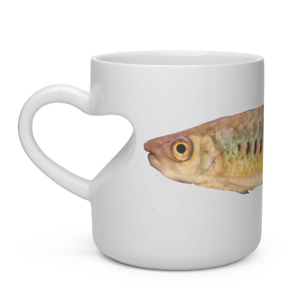 A white ceramic heart-shaped mug with a colorful fish design and a heart-shaped handle, perfect for hot beverages.
