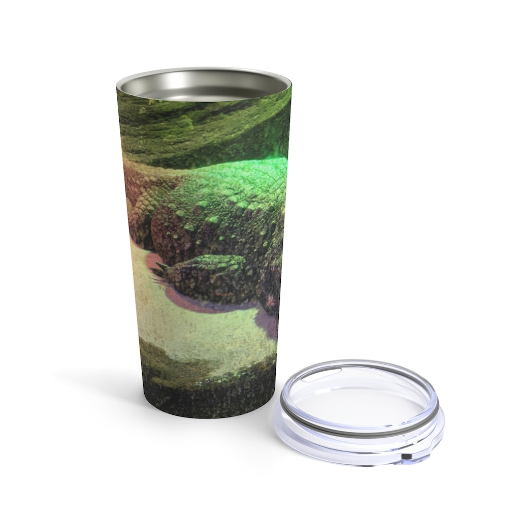 Crocodile Tumbler 20oz in stainless steel with a see-thru plastic lid, showcasing its sleek design and rounded corners.