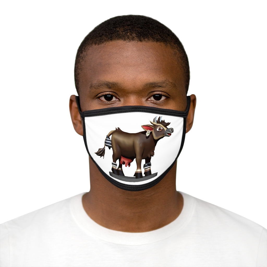 Dark brown cow print face mask with black edges and earloops, made from mixed fabrics for comfort and style.