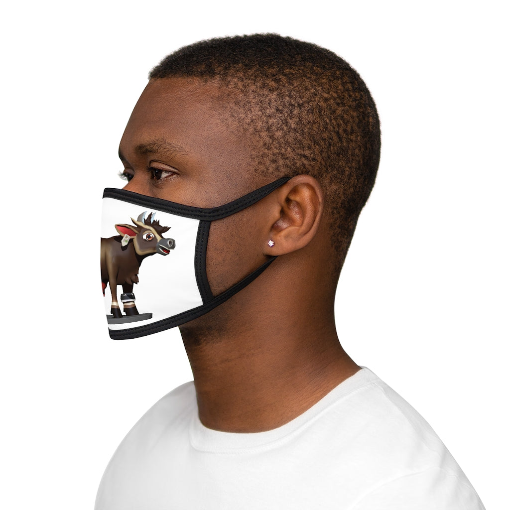 Dark brown cow print face mask with black edges and earloops, made from mixed fabrics for comfort and style.