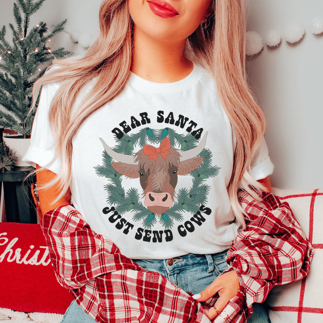 A festive Dear Santa Just Send Cows Tee made from 100% soft cotton, featuring a playful holiday design.
