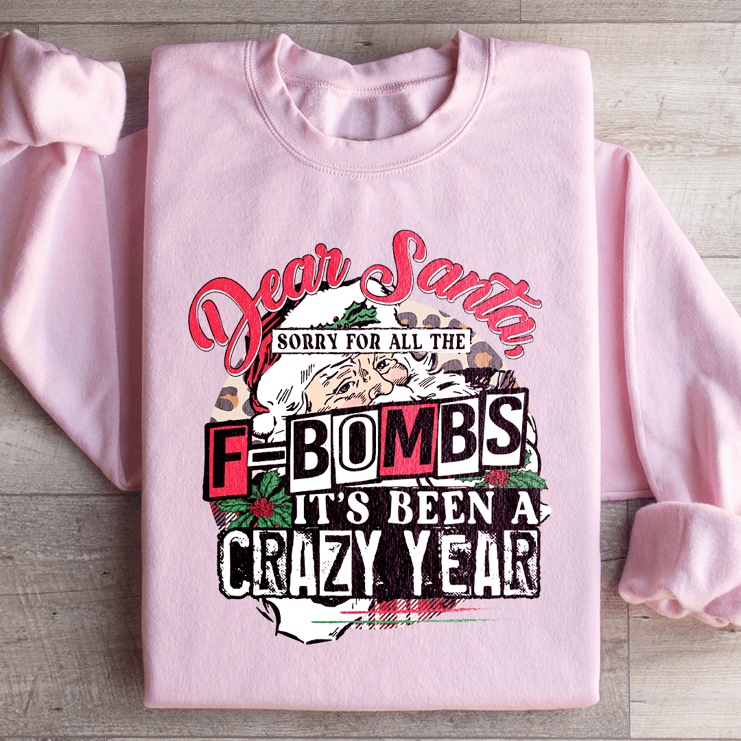 A cozy hoodie featuring the phrase 'Dear Santa Sorry For All The F Bombs', designed by top artists, made from a warm cotton/poly fleece blend.