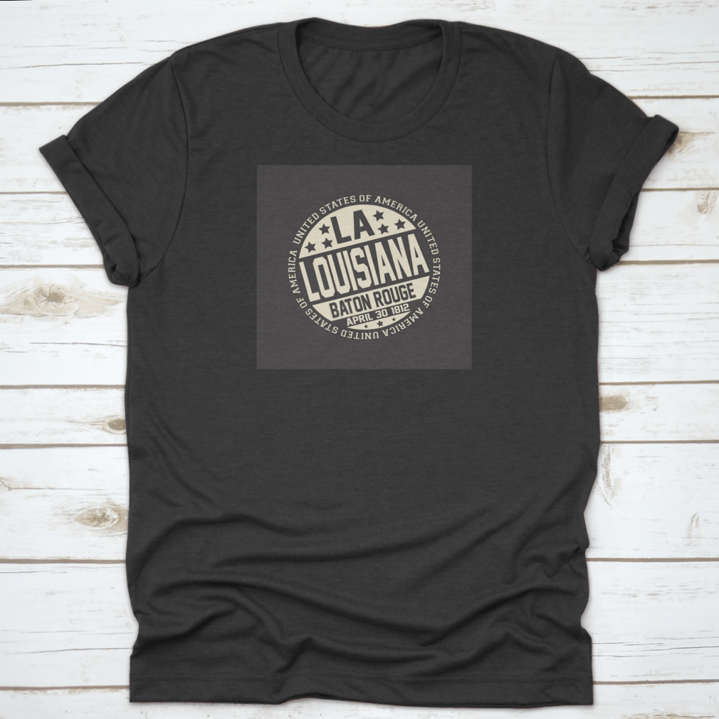 Decorative stamp t-shirt featuring LA postal abbreviation on a black background, showcasing a stylish design.