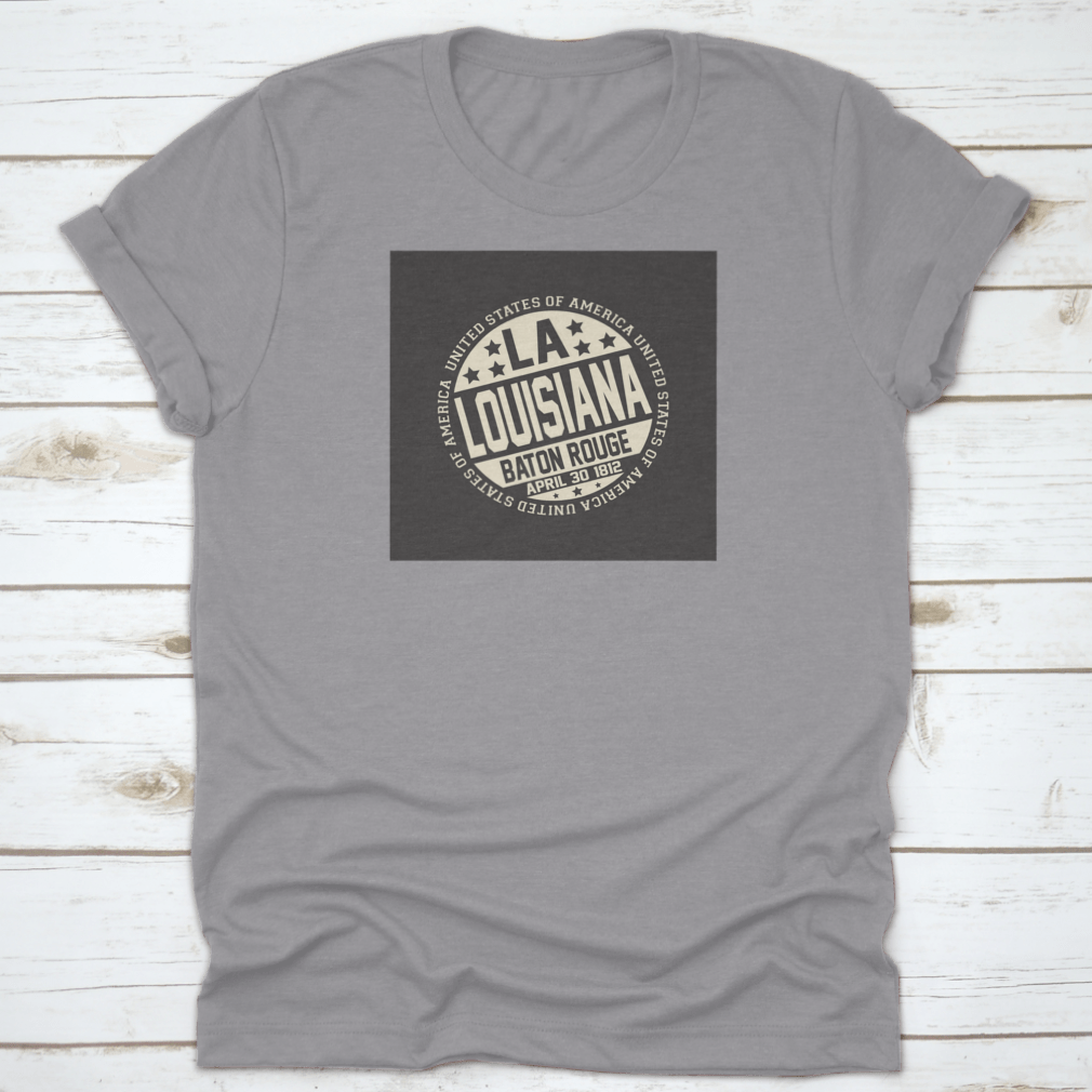 Decorative stamp t-shirt featuring LA postal abbreviation on a black background, showcasing a stylish design.