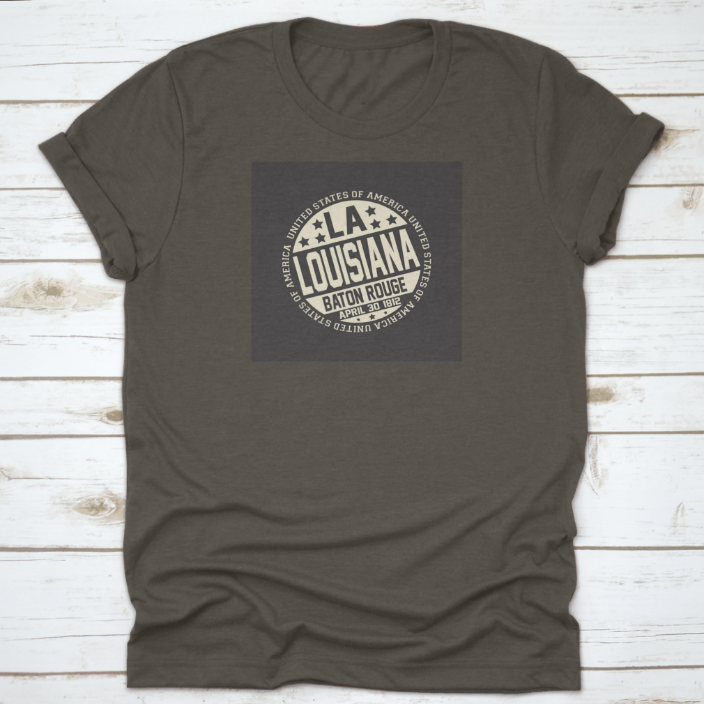 Decorative stamp t-shirt featuring LA postal abbreviation on a black background, showcasing a stylish design.