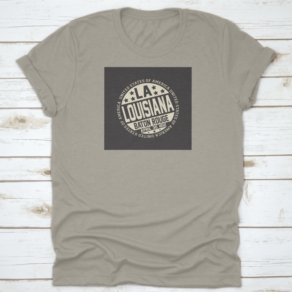 Decorative stamp t-shirt featuring LA postal abbreviation on a black background, showcasing a stylish design.