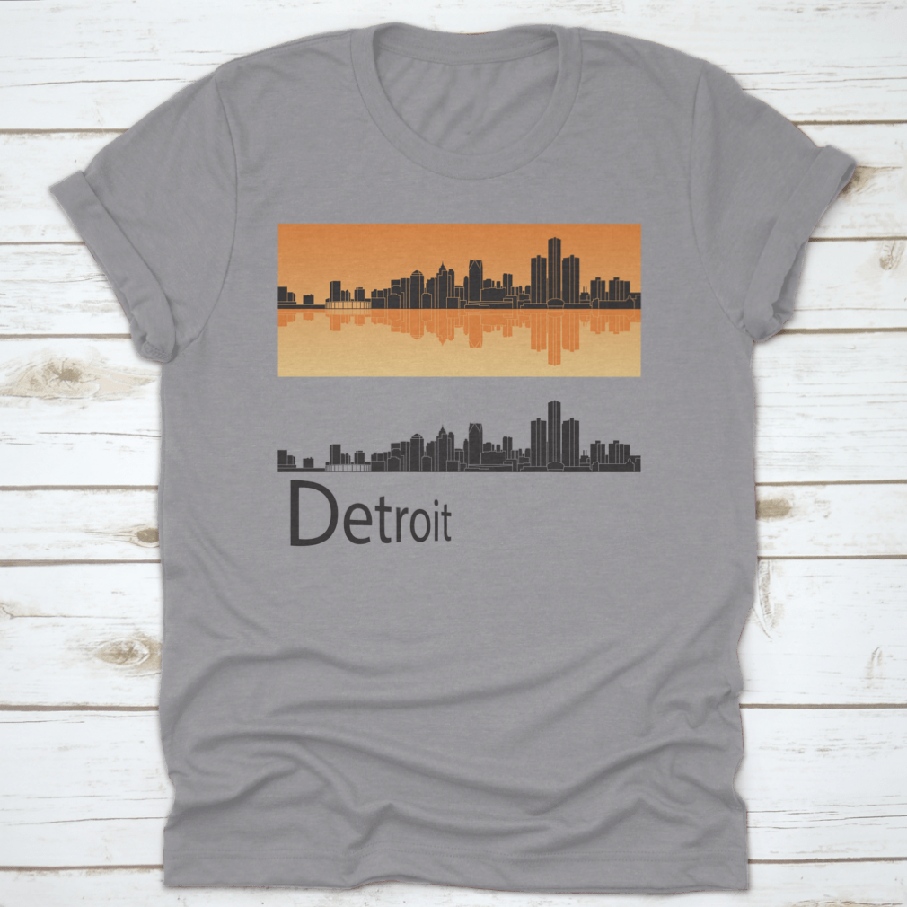 A vibrant orange t-shirt featuring the Detroit skyline reflected against a bright background, showcasing the city's iconic architecture.