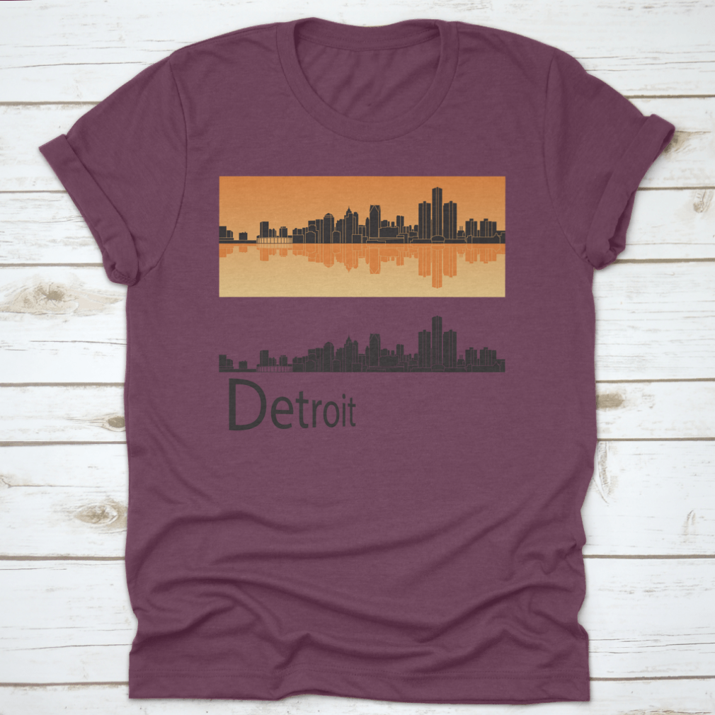 A vibrant orange t-shirt featuring the Detroit skyline reflected against a bright background, showcasing the city's iconic architecture.