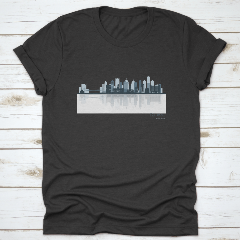 A stylish t-shirt featuring the Detroit skyline silhouette with reflection, showcasing iconic buildings in a modern design.