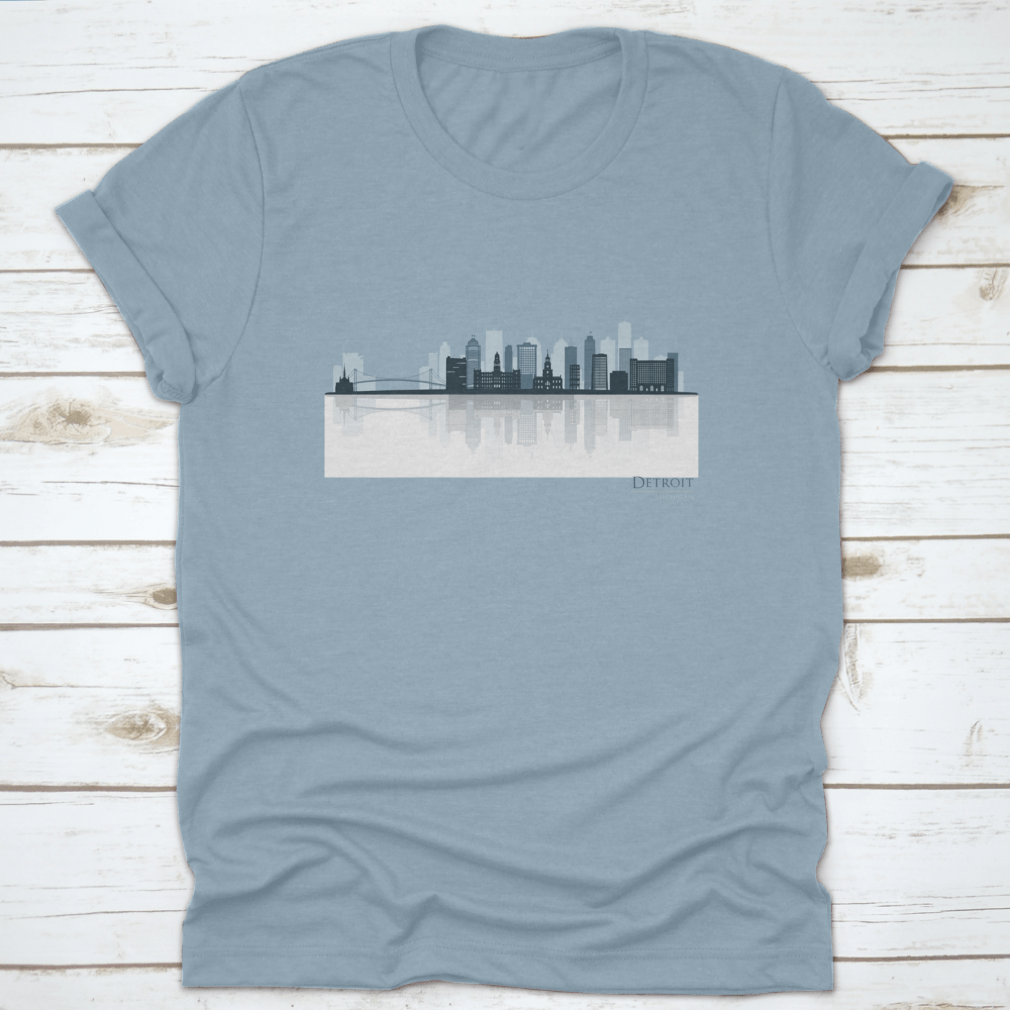A stylish t-shirt featuring the Detroit skyline silhouette with reflection, showcasing iconic buildings in a modern design.