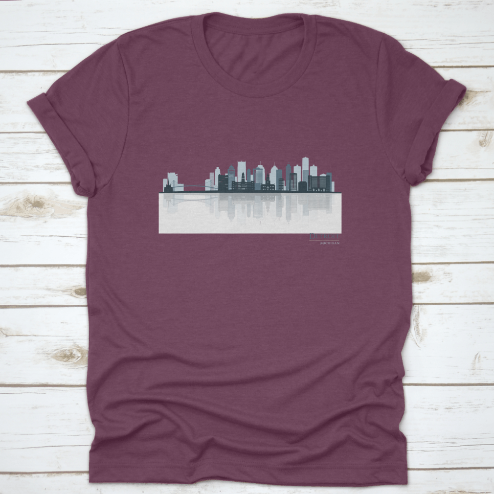 A stylish t-shirt featuring the Detroit skyline silhouette with reflection, showcasing iconic buildings in a modern design.