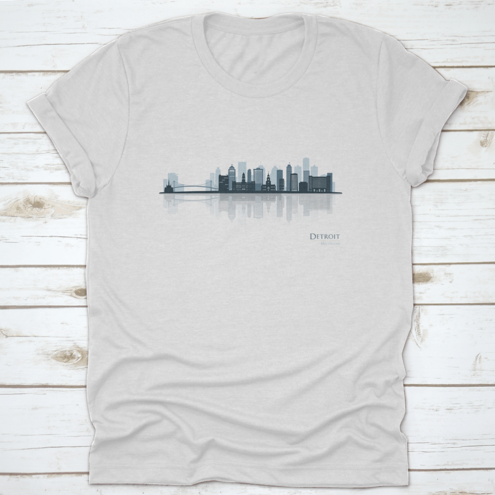 A stylish t-shirt featuring the Detroit skyline silhouette with reflection, showcasing iconic buildings in a modern design.