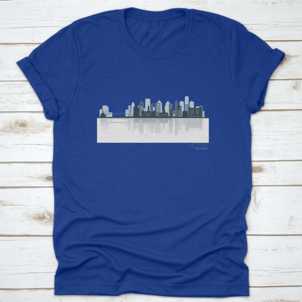 A stylish t-shirt featuring the Detroit skyline silhouette with reflection, showcasing iconic buildings in a modern design.