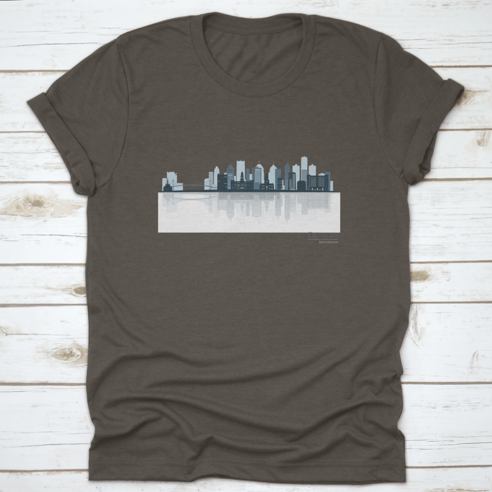A stylish t-shirt featuring the Detroit skyline silhouette with reflection, showcasing iconic buildings in a modern design.