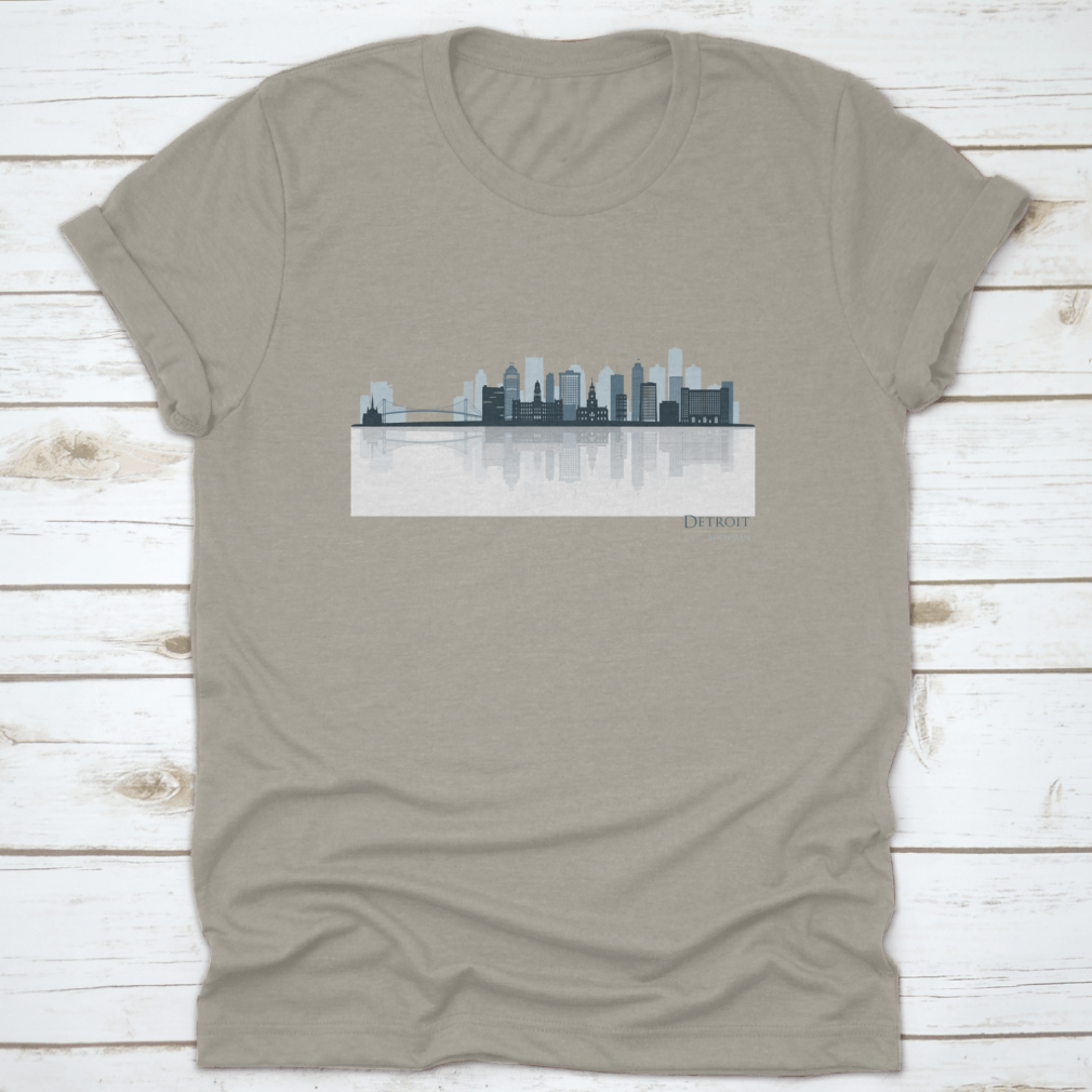 A stylish t-shirt featuring the Detroit skyline silhouette with reflection, showcasing iconic buildings in a modern design.