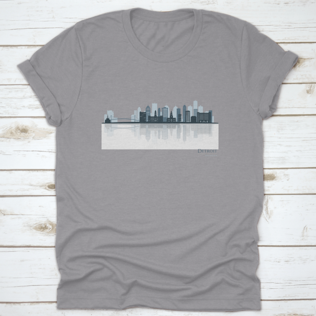 A stylish t-shirt featuring the Detroit skyline silhouette with reflection, showcasing iconic buildings in a modern design.
