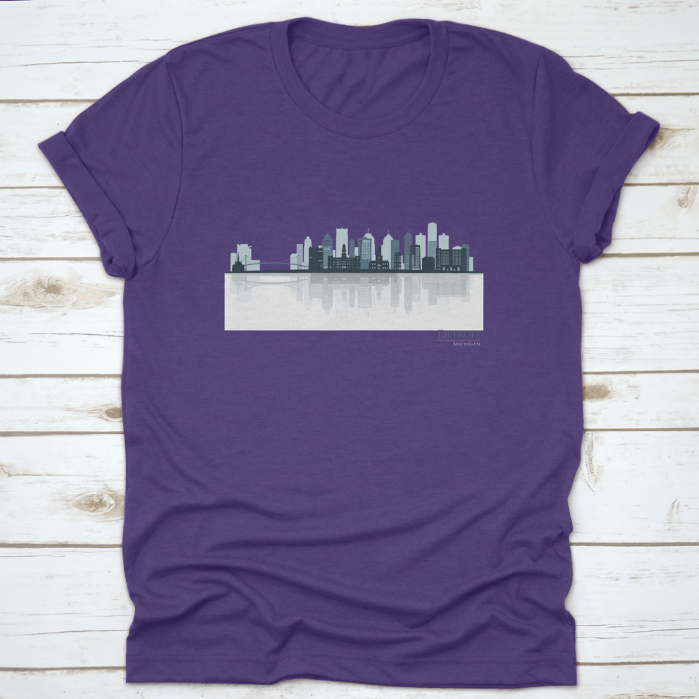 A stylish t-shirt featuring the Detroit skyline silhouette with reflection, showcasing iconic buildings in a modern design.